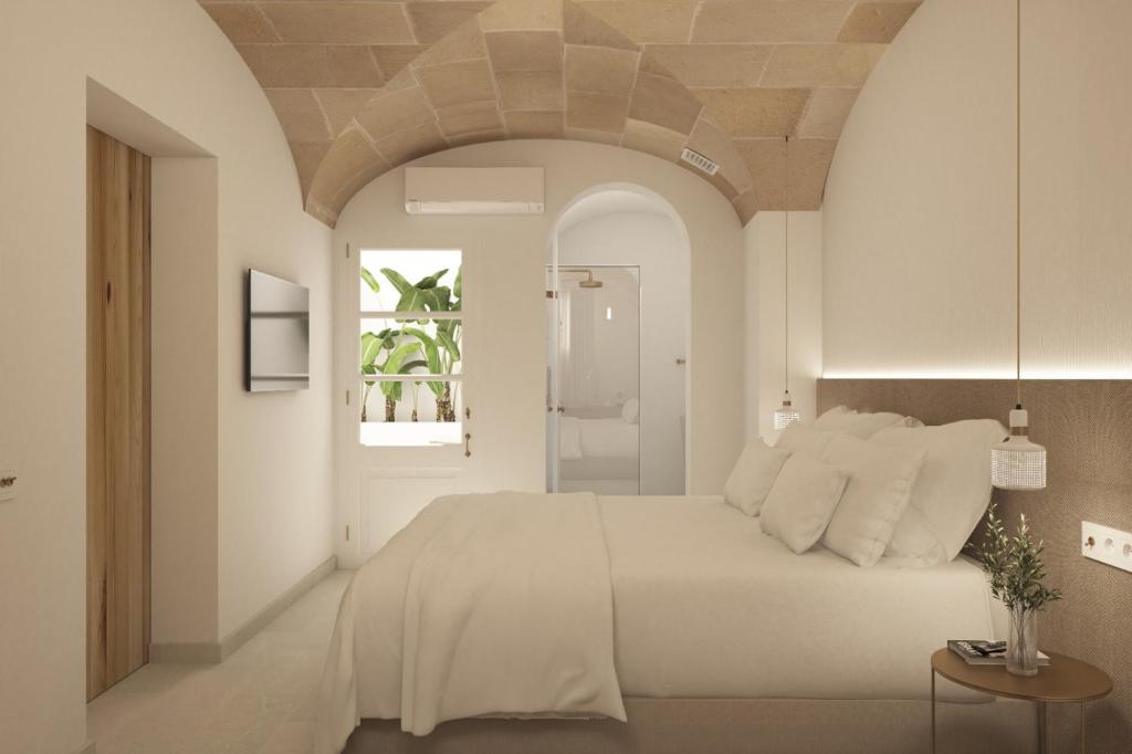 a bedroom with a large white bed and a window at LLONGA'S 7th in Ciutadella