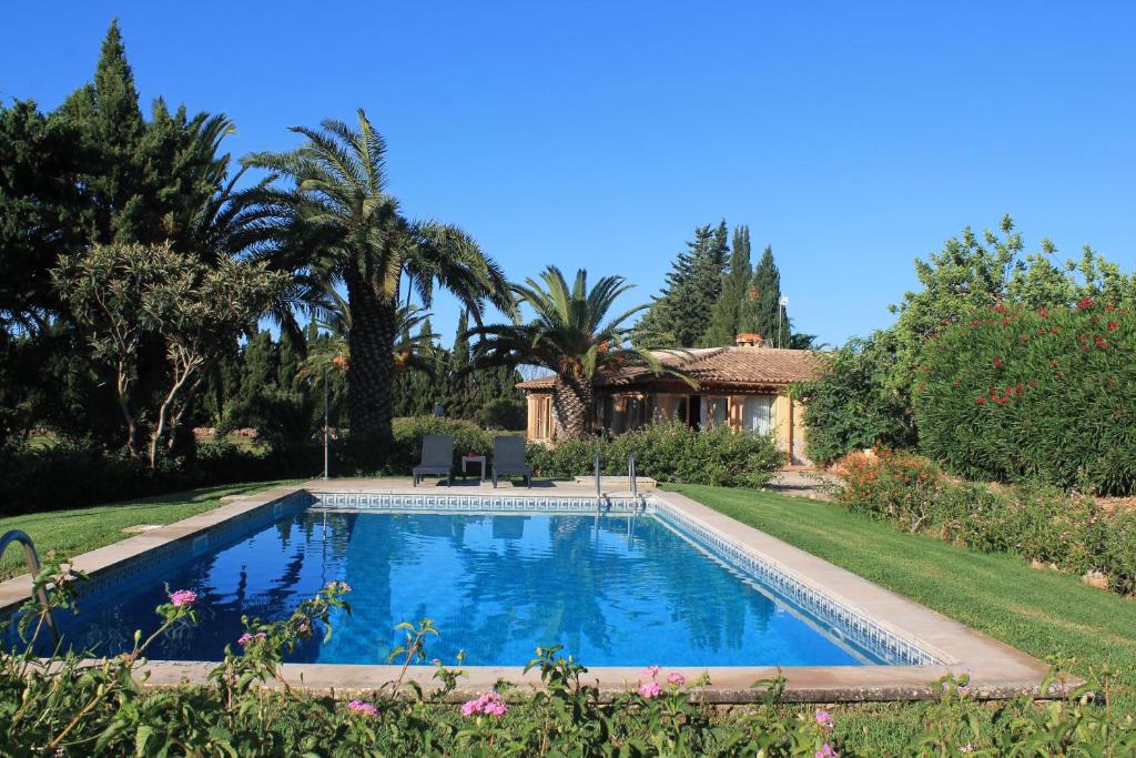 a swimming pool in the yard of a house at Finca Verde in Llucmajor