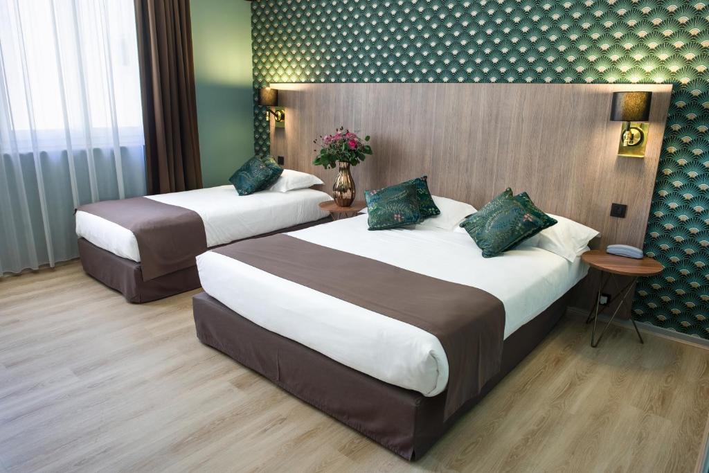 Postel nebo postele na pokoji v ubytování Hôtel Le Bristol