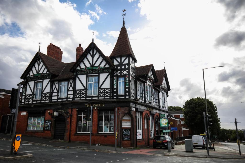 a black and white building on the corner of a street at The Valley Rooms in Liverpool