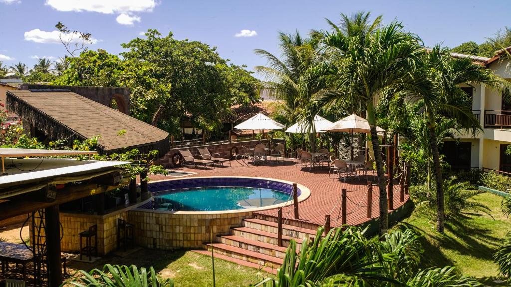 a resort with a swimming pool and a patio at Kanaloa Pousada in Jericoacoara