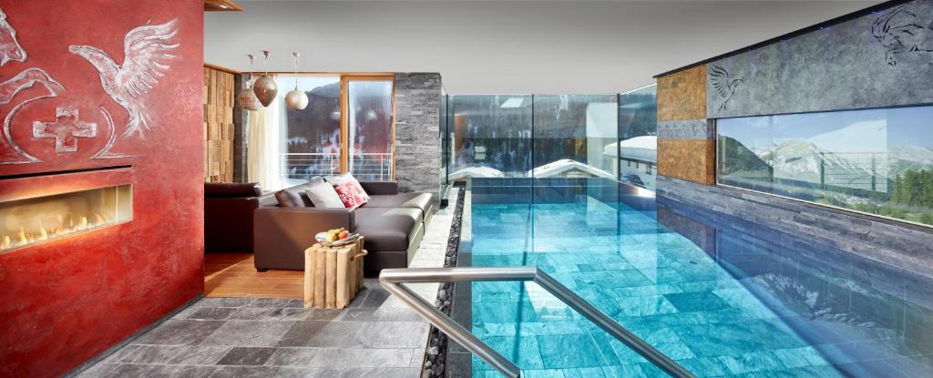 ein Haus mit einem Pool in einem Zimmer in der Unterkunft Alpinlodge & Spa in Samnaun