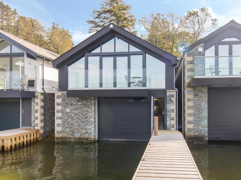 a house on a body of water at Boathouse on the Lake in Windermere