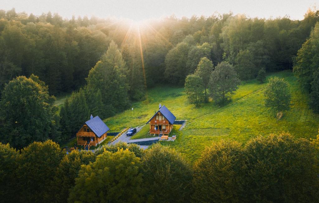 an aerial view of a house on a hill at Osada Dzika - domy z bali in Uherce Mineralne (7)