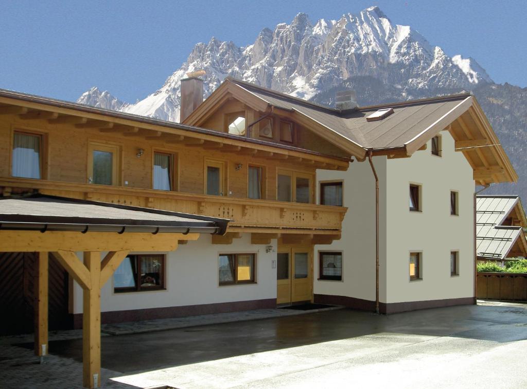 a building with a mountain in the background at Appartement Barbara in Sankt Johann in Tirol