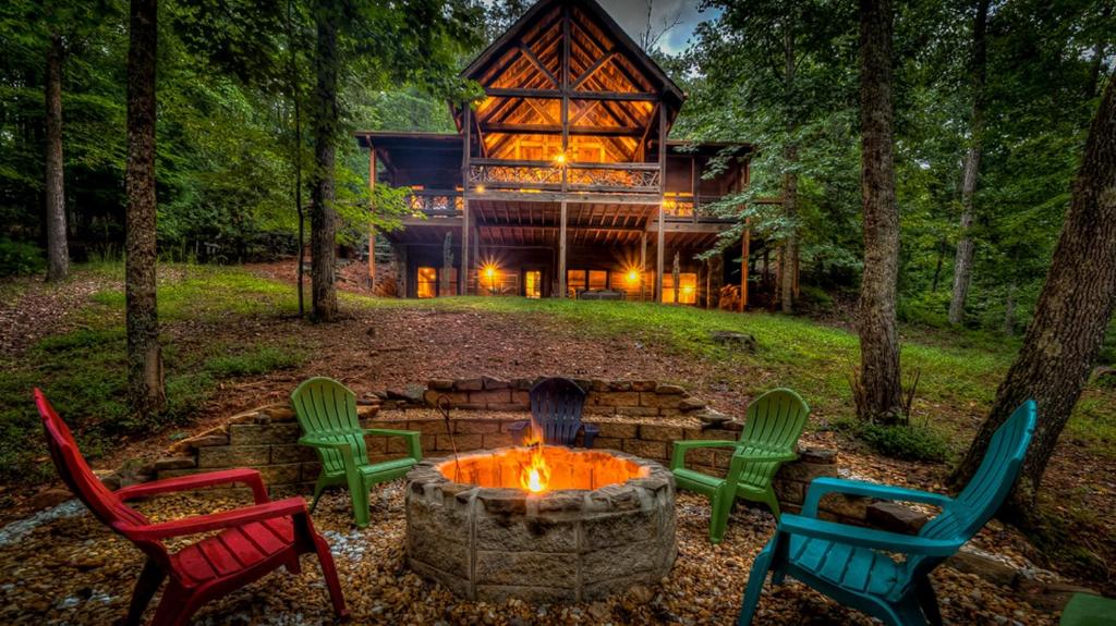 a group of chairs around a fire pit in front of a house at Winding Log Ridge in Blue Ridge
