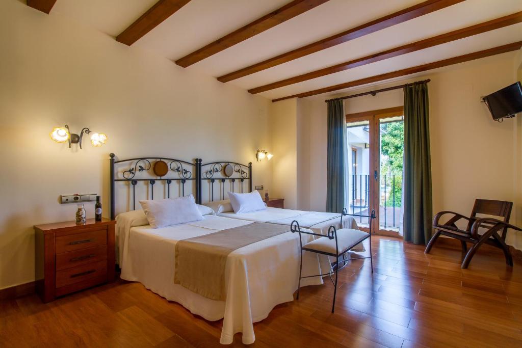 a bedroom with a large bed and a wooden floor at Hotel Tossal d'Altea in Altea