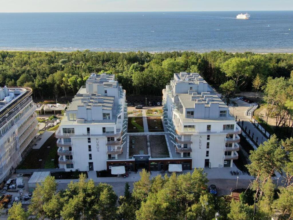 an aerial view of two white buildings next to the ocean at Apartament RUBUS 007 in Świnoujście