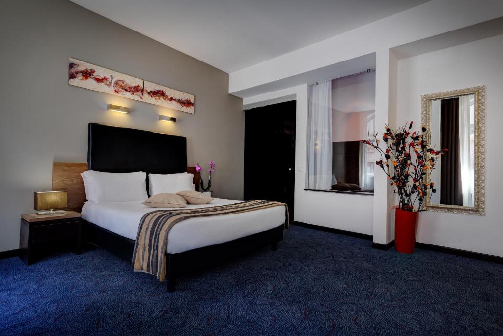 Postel nebo postele na pokoji v ubytování Hotel Rinascimento - Gruppo Trevi Hotels