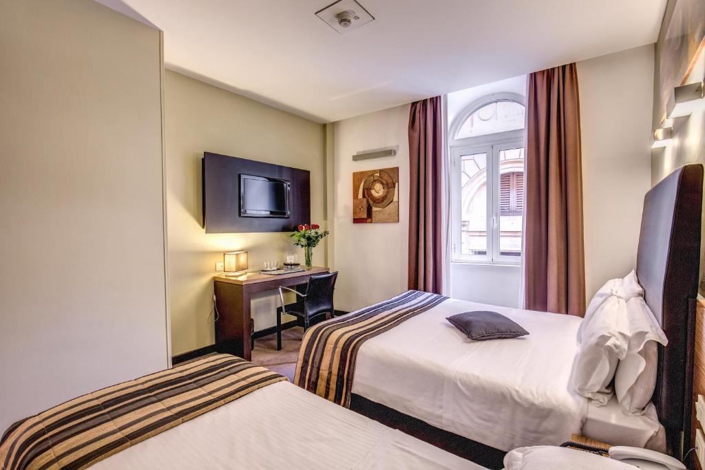 Postel nebo postele na pokoji v ubytování Hotel Rinascimento - Gruppo Trevi Hotels