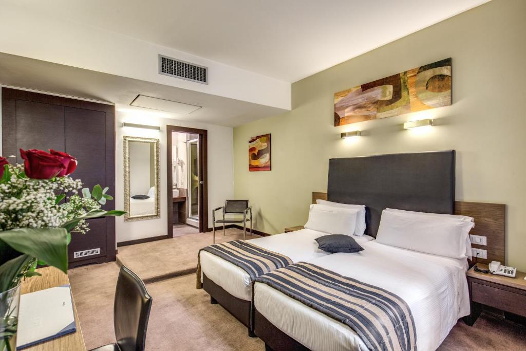Postel nebo postele na pokoji v ubytování Hotel Rinascimento - Gruppo Trevi Hotels