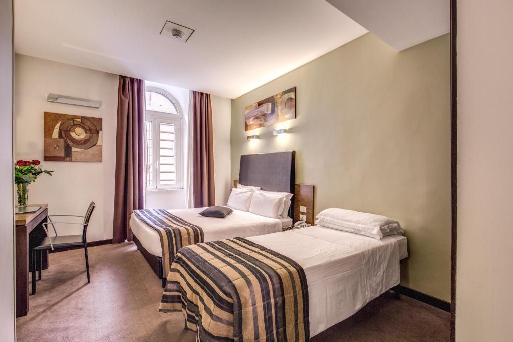 Postel nebo postele na pokoji v ubytování Hotel Rinascimento - Gruppo Trevi Hotels