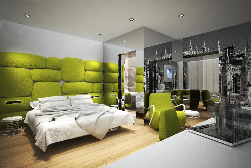 a bedroom with a large bed with a green headboard at The Street Milano Duomo | a Design Boutique Hotel in Milan