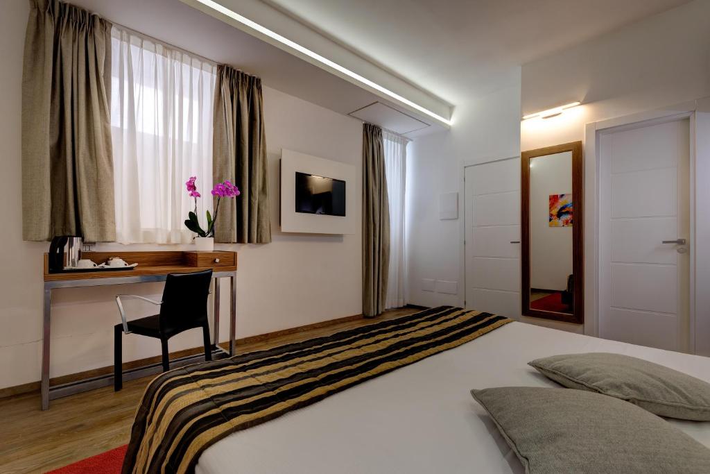 Postel nebo postele na pokoji v ubytování Hotel Rinascimento - Gruppo Trevi Hotels