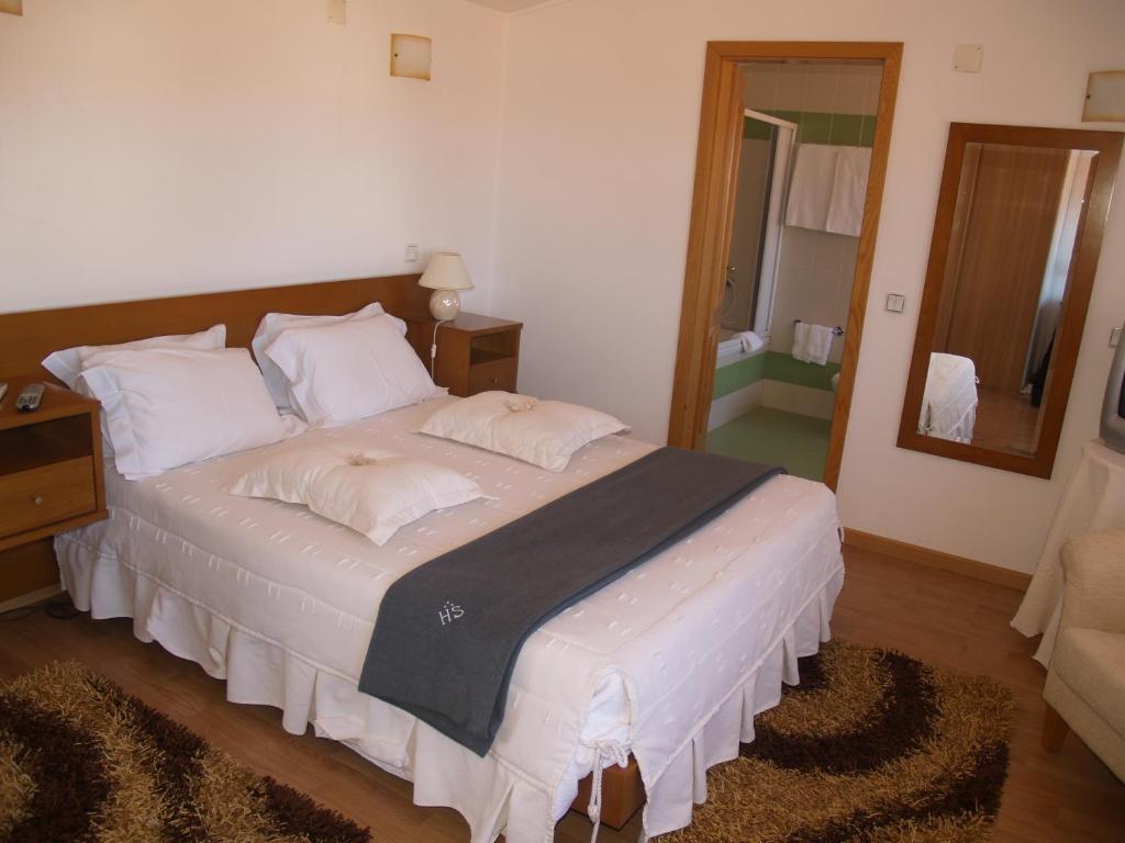 Postel nebo postele na pokoji v ubytování Hotel Santos