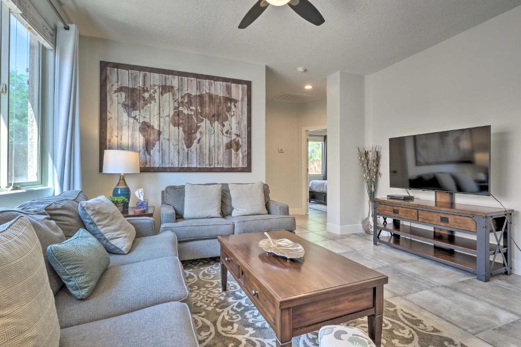 a living room with a couch and a tv at Dtwn Mesquite Condo with Resort Pool Golf and Gamble! in Mesquite