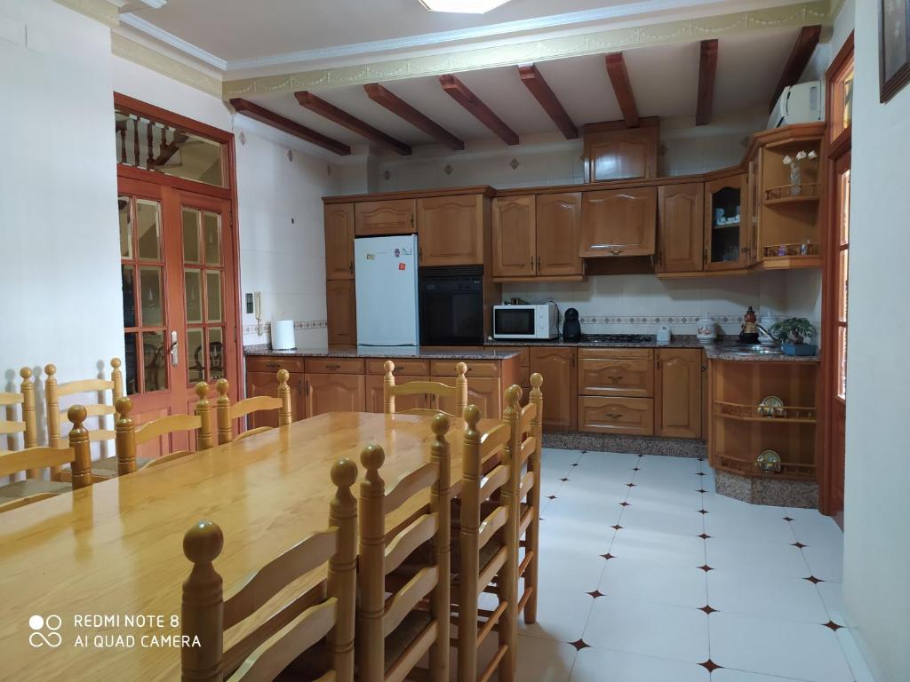 une cuisine avec des placards en bois et une table en bois dans l'établissement Casa MarTa, à Chella