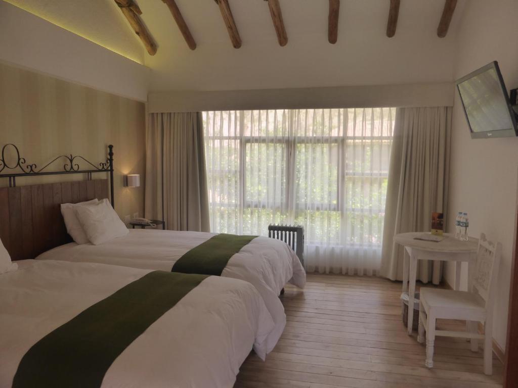 Postel nebo postele na pokoji v ubytování Hotel La Casona De Yucay Valle Sagrado