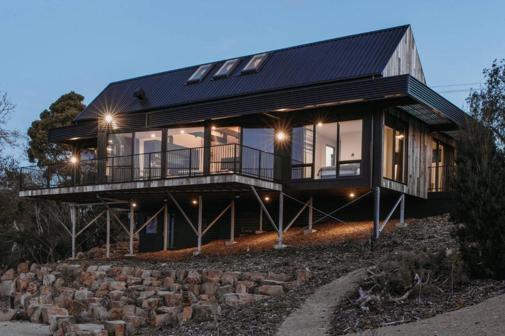 a house on top of a hill with lights at Deviot Boat House in Deviot