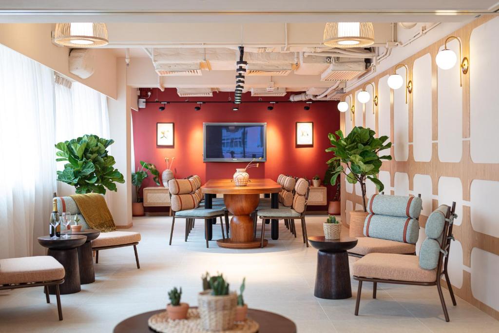 a waiting room with a table and chairs at the Figo in Hong Kong