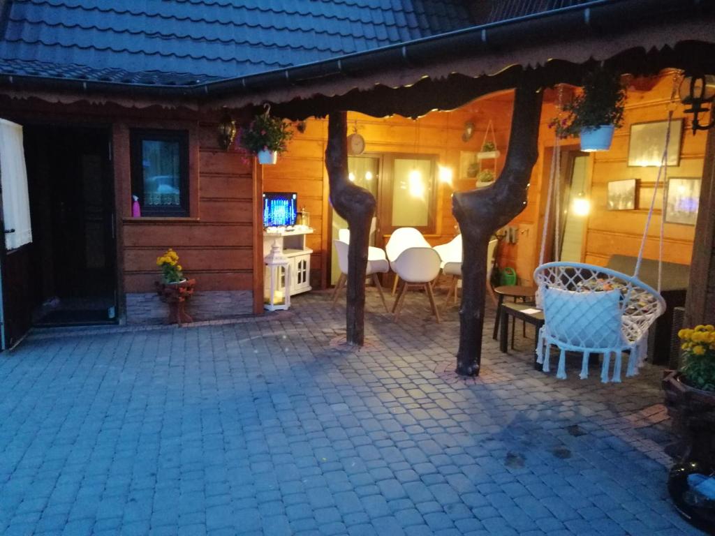 a patio of a house with a table and chairs at Domek u Magdy in Zakopane