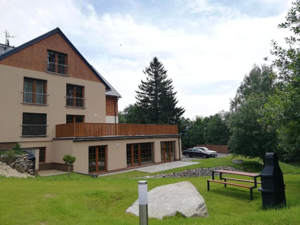 a building with a bench in front of it at Apartmány Říčky in Říčky