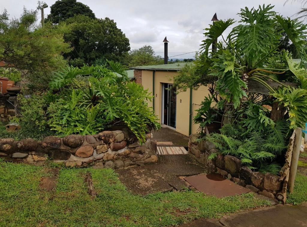a house with trees and plants in front of it at Guesthouse 914 in Sabie