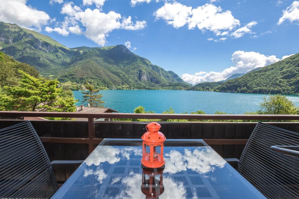 a table with a light on top of a view of a lake at Serena Charme View in Mezzolago