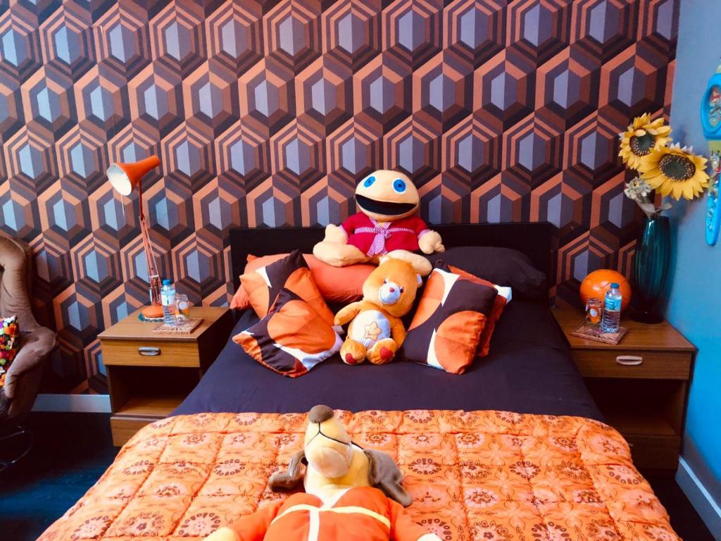 a bedroom with two stuffed animals on a bed at The Retro Retreat with free parking in Hastings
