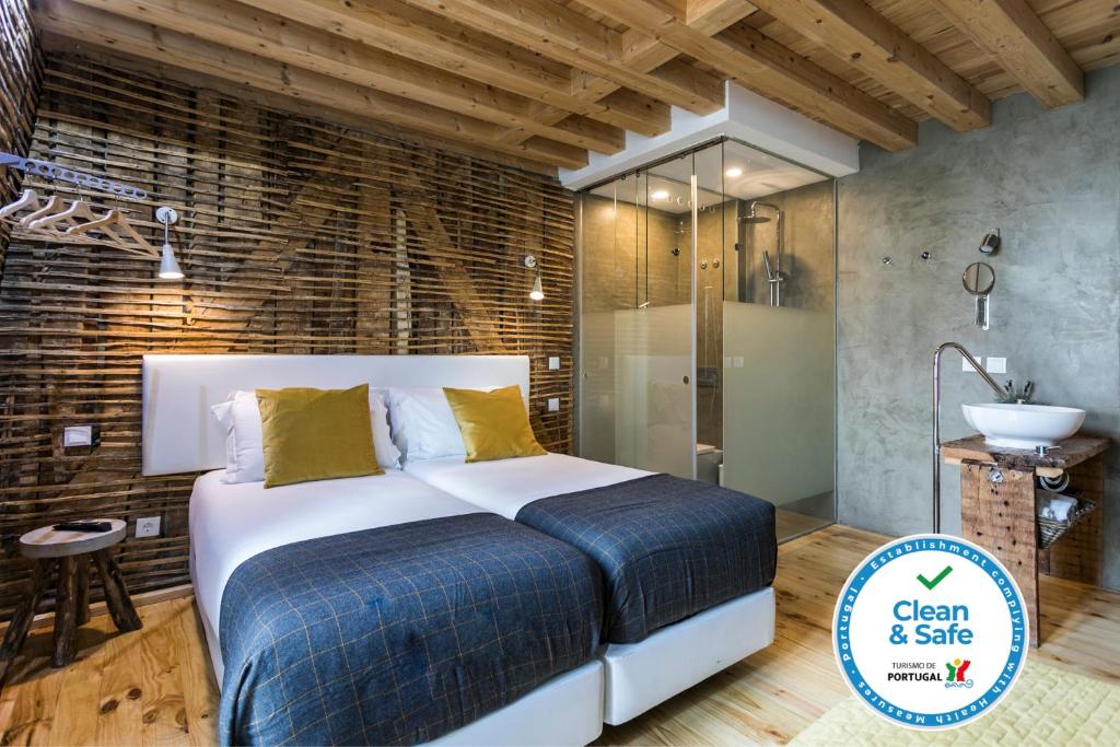 a bedroom with a large bed and a bathroom at 262 Boutique Hotel in Lisbon