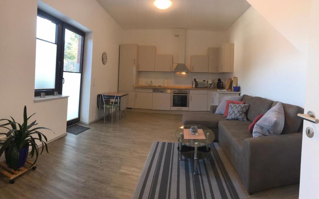 a living room with a couch and a table at Ferienwohnung I in Papenburg