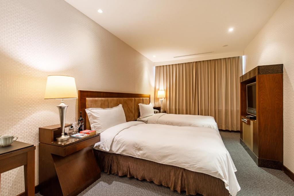 Postel nebo postele na pokoji v ubytování Hotel HD Palace
