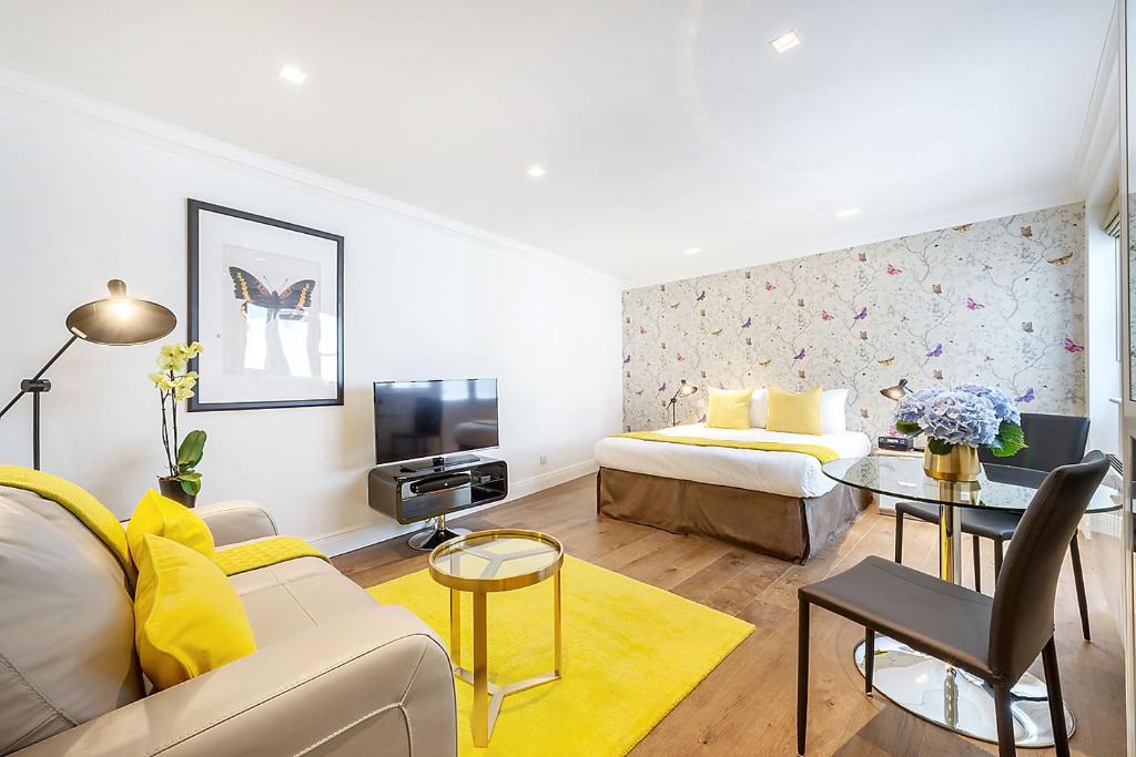 a living room with a couch and a table at Marylebone - Wyndham Street by Viridian Apartments in London