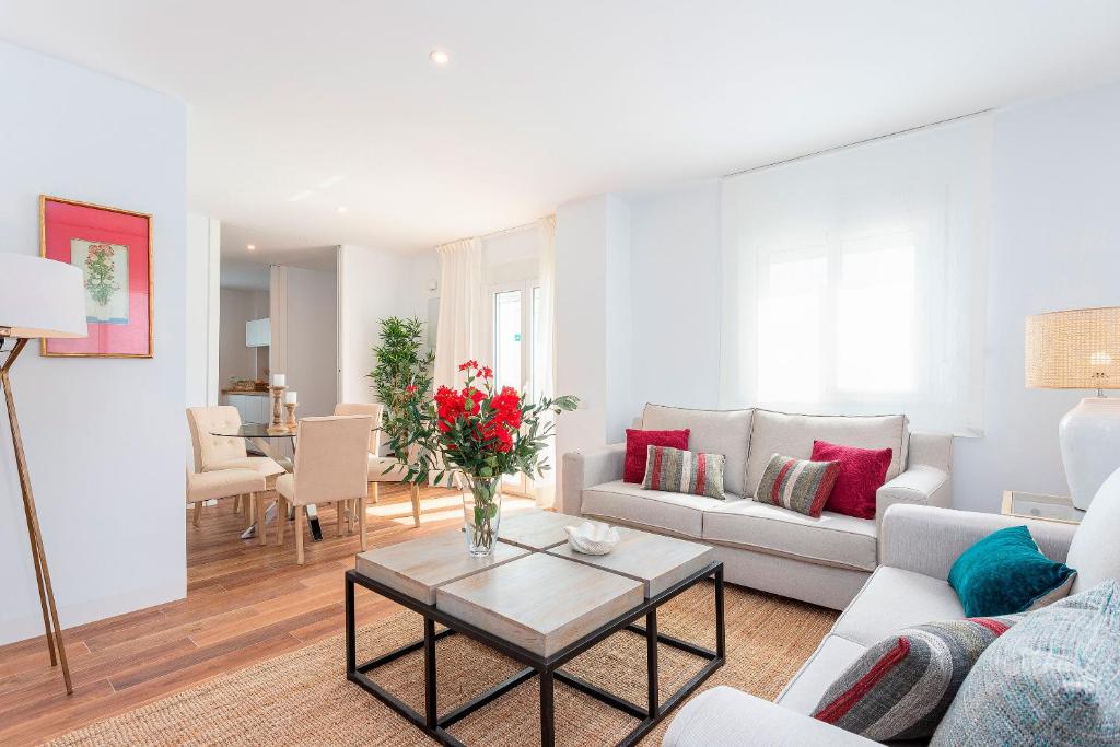 a living room with a couch and a table at Genteel Home San Antonio in Cádiz