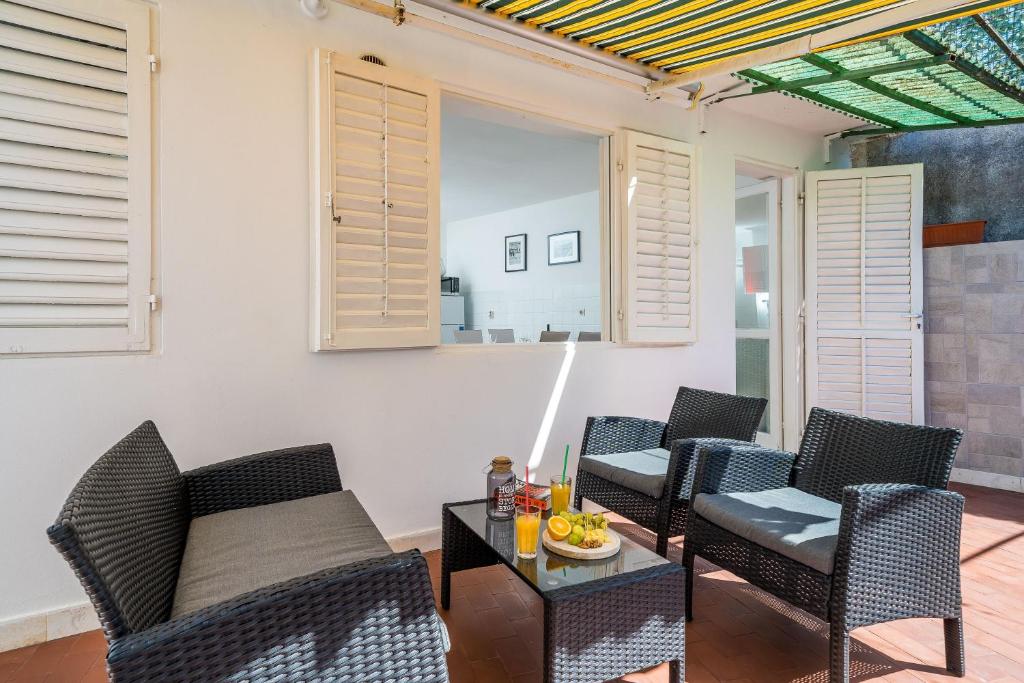 a living room with chairs and a table at Apartment Laura - Lapad in Dubrovnik