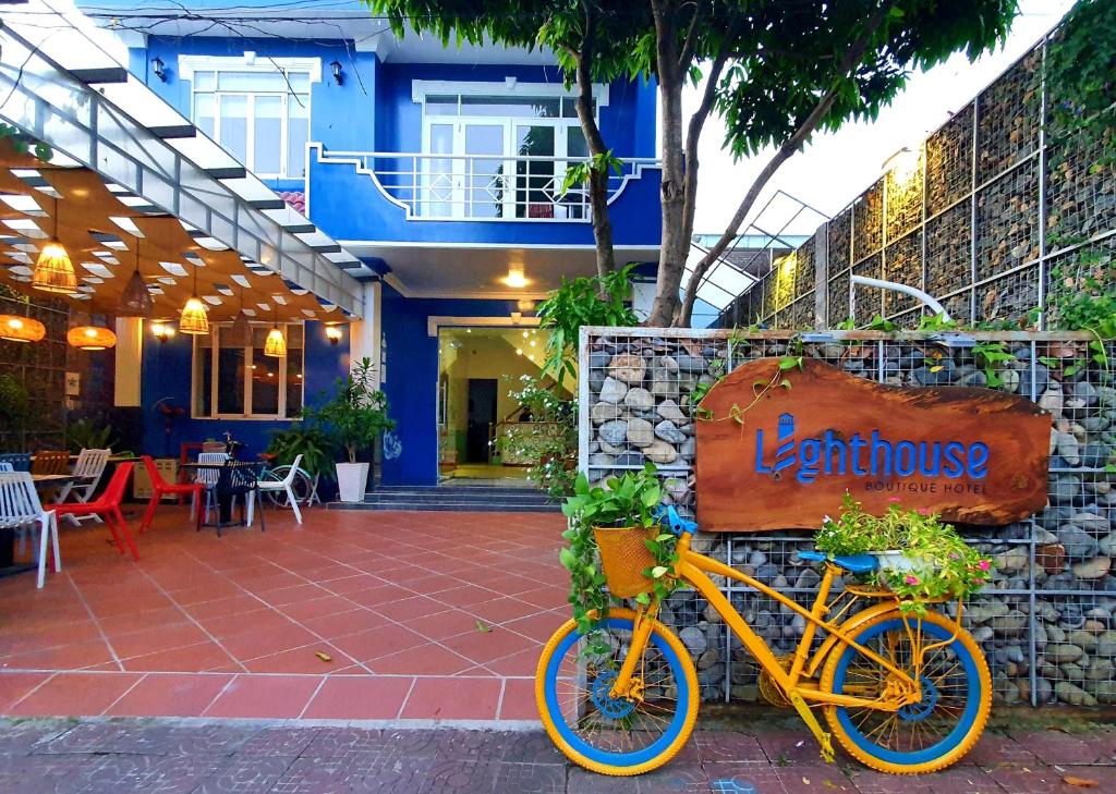a yellow bike parked in front of a building at Lighthouse Boutique Hotel Côn Đảo in Con Dao
