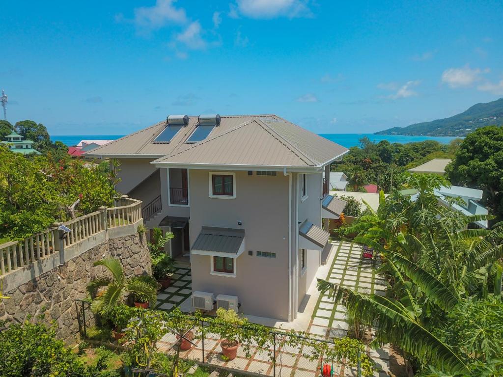 an aerial view of a house with the ocean in the background at Whispering Palms in Bel Ombre