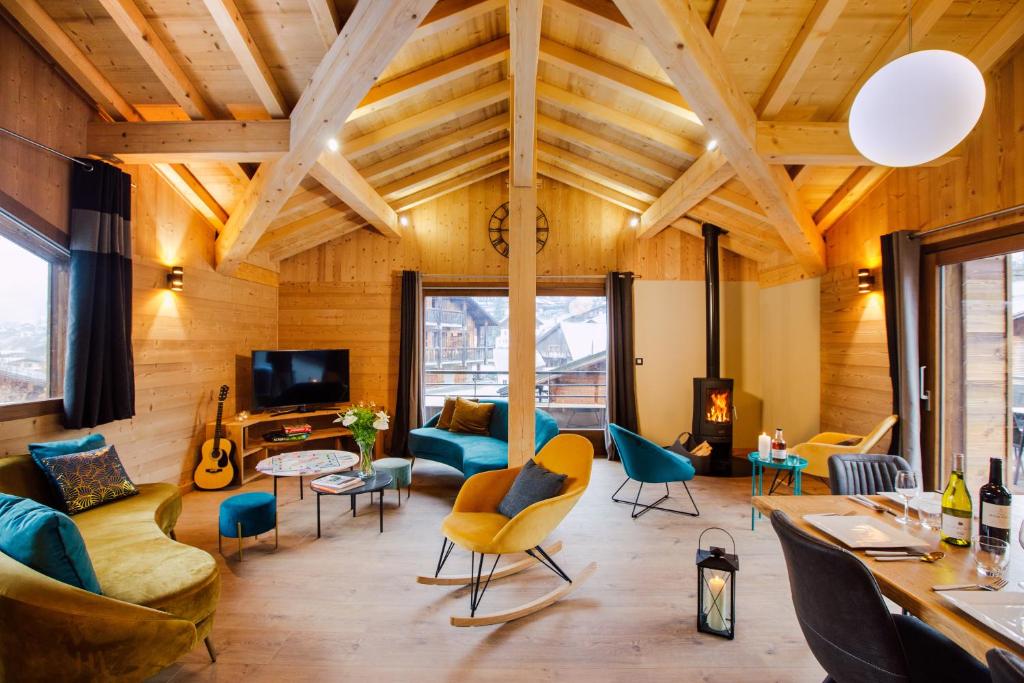 a living room with wooden ceilings and furniture at Chalet Melodie in Morzine