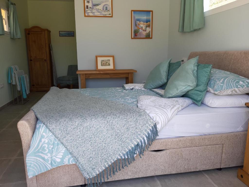 uma cama com um cobertor azul e branco em Los Torres Casa Lindsay em Arboleas