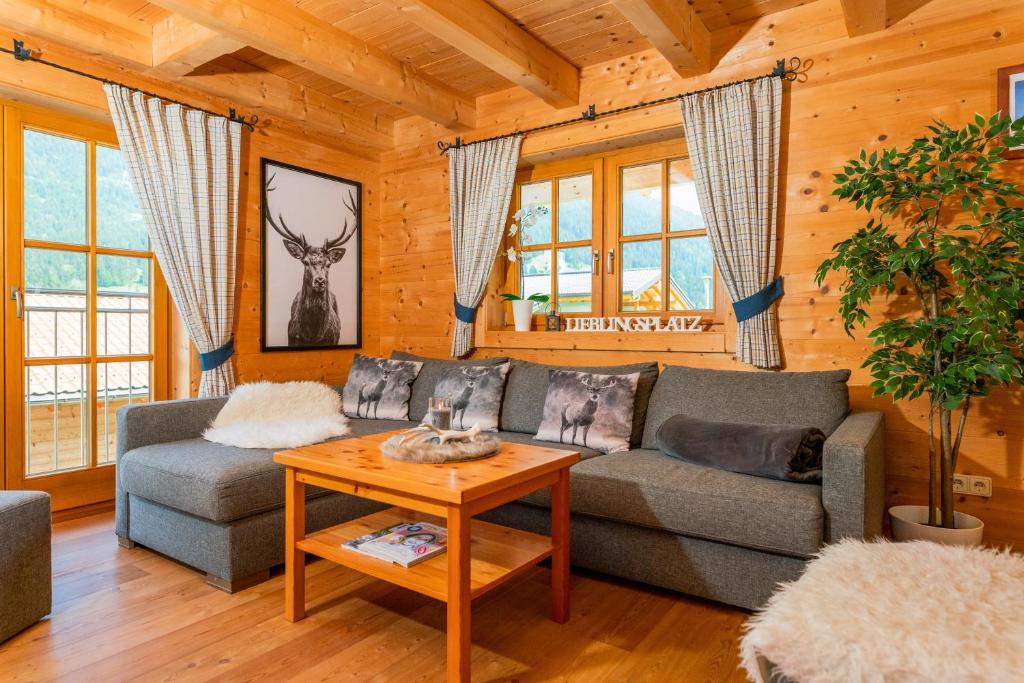a living room with a couch and a table at Berg Chalet in Annaberg im Lammertal