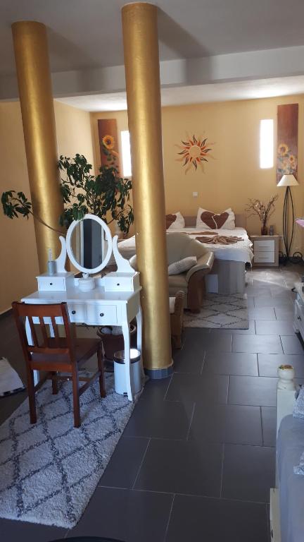 a large living room with a column and a mirror at Apartman studio in Vela Luka