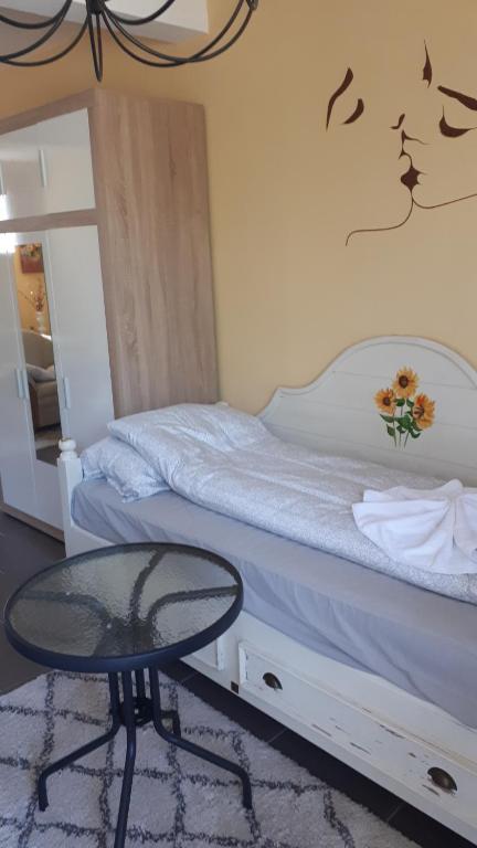 a bedroom with a bed with a table and a mirror at Apartman studio in Vela Luka