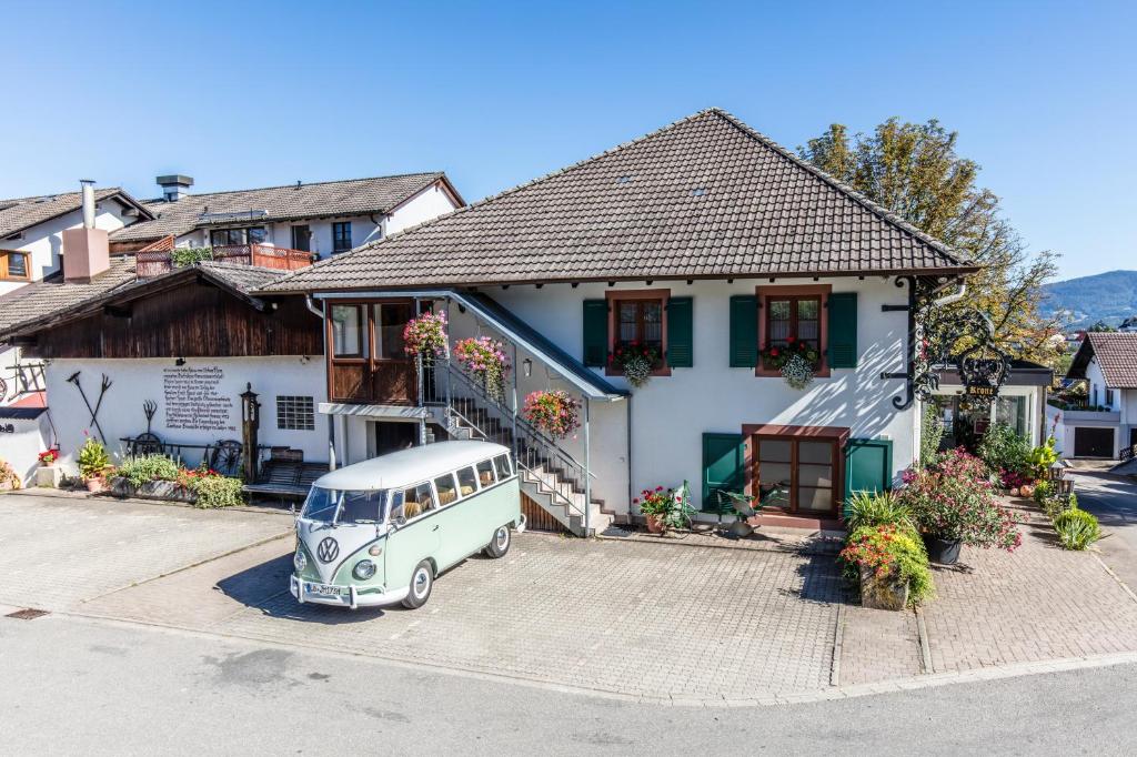 an old van parked in front of a house at Hotel Restaurant Krone & Wellness - Schopfheim in Schopfheim