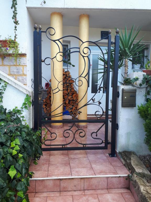 an iron gate with a bunch of pine needles at Apartman studio in Vela Luka