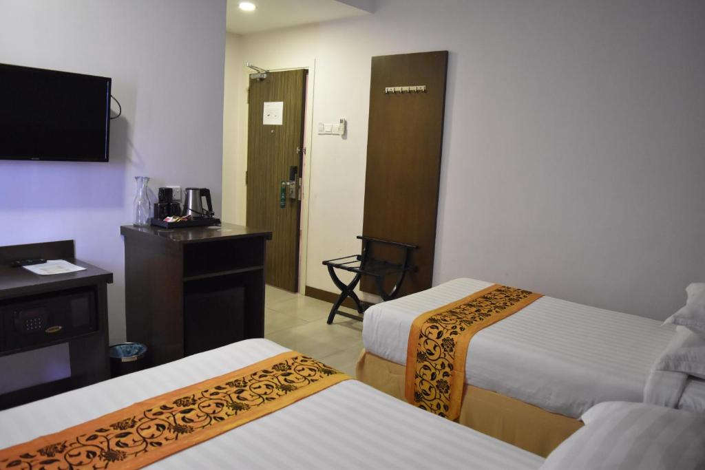 Postel nebo postele na pokoji v ubytování Sunrise Hotel
