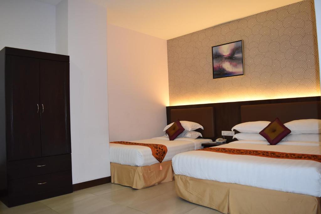 Postel nebo postele na pokoji v ubytování Sunrise Hotel