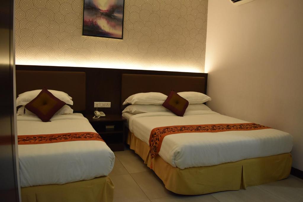 Postel nebo postele na pokoji v ubytování Sunrise Hotel