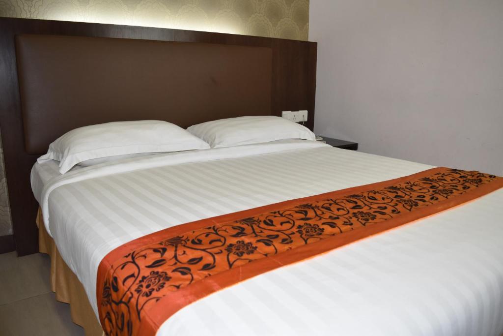 Postel nebo postele na pokoji v ubytování Sunrise Hotel