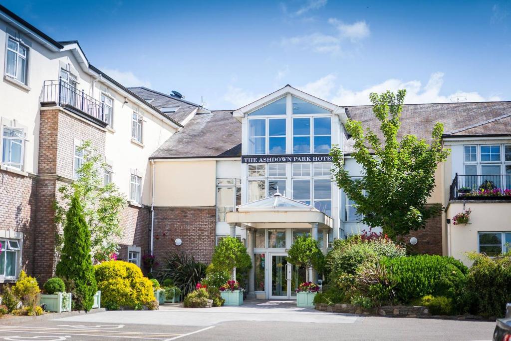 an exterior view of a building with windows and plants at Ashdown Park Hotel in Gorey