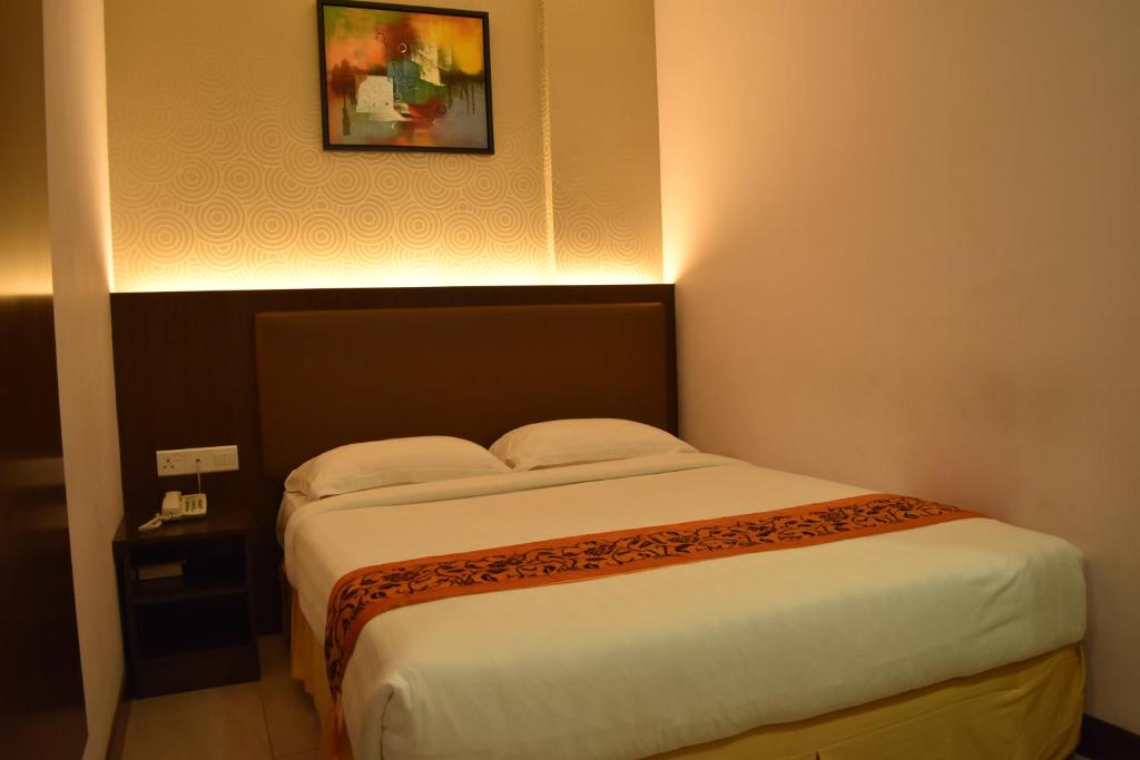 Postel nebo postele na pokoji v ubytování Sunrise Hotel